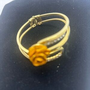 Vintage hinged bracelet with gold-tone rose and bling